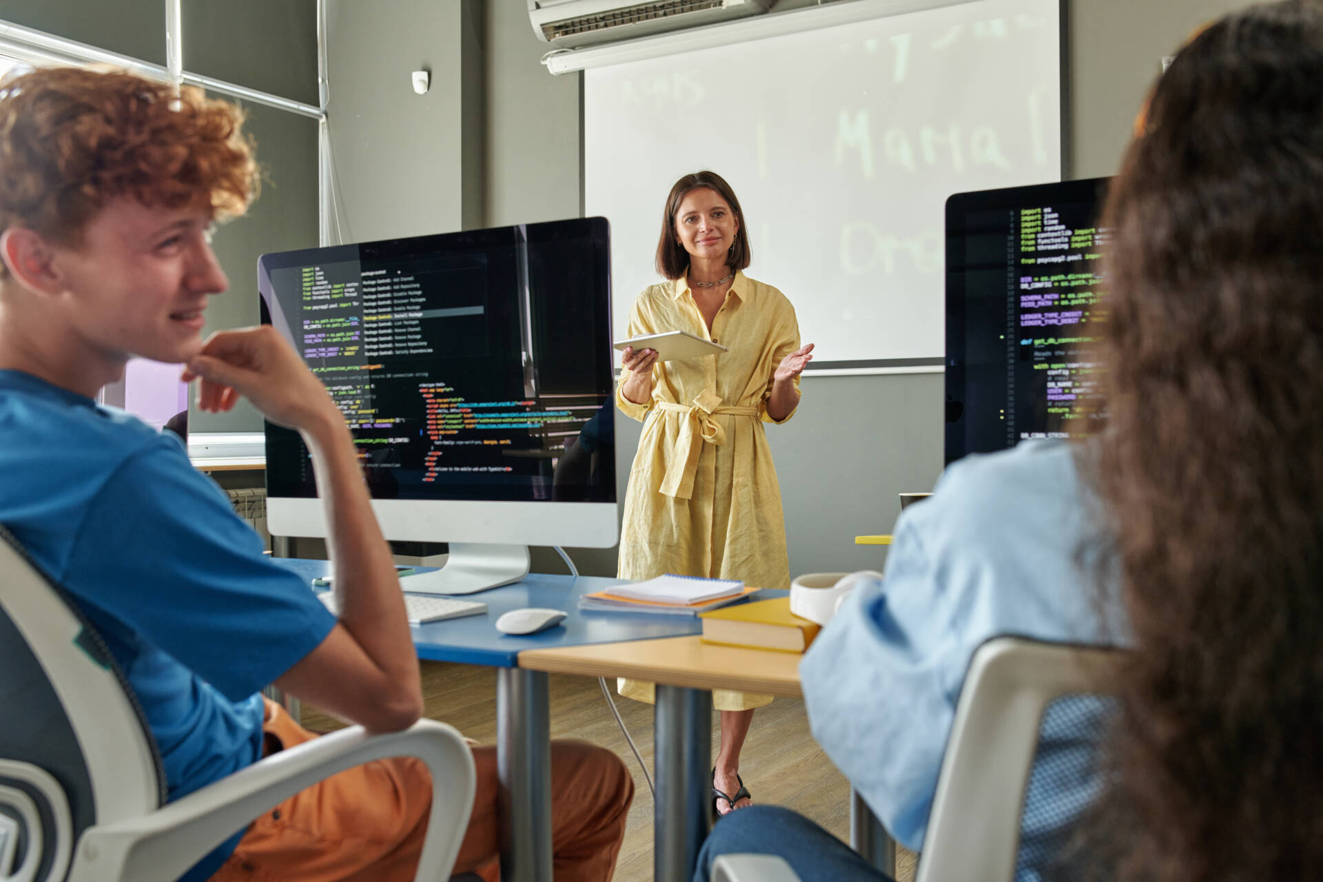 Female Teacher Talking to People IT Class in School